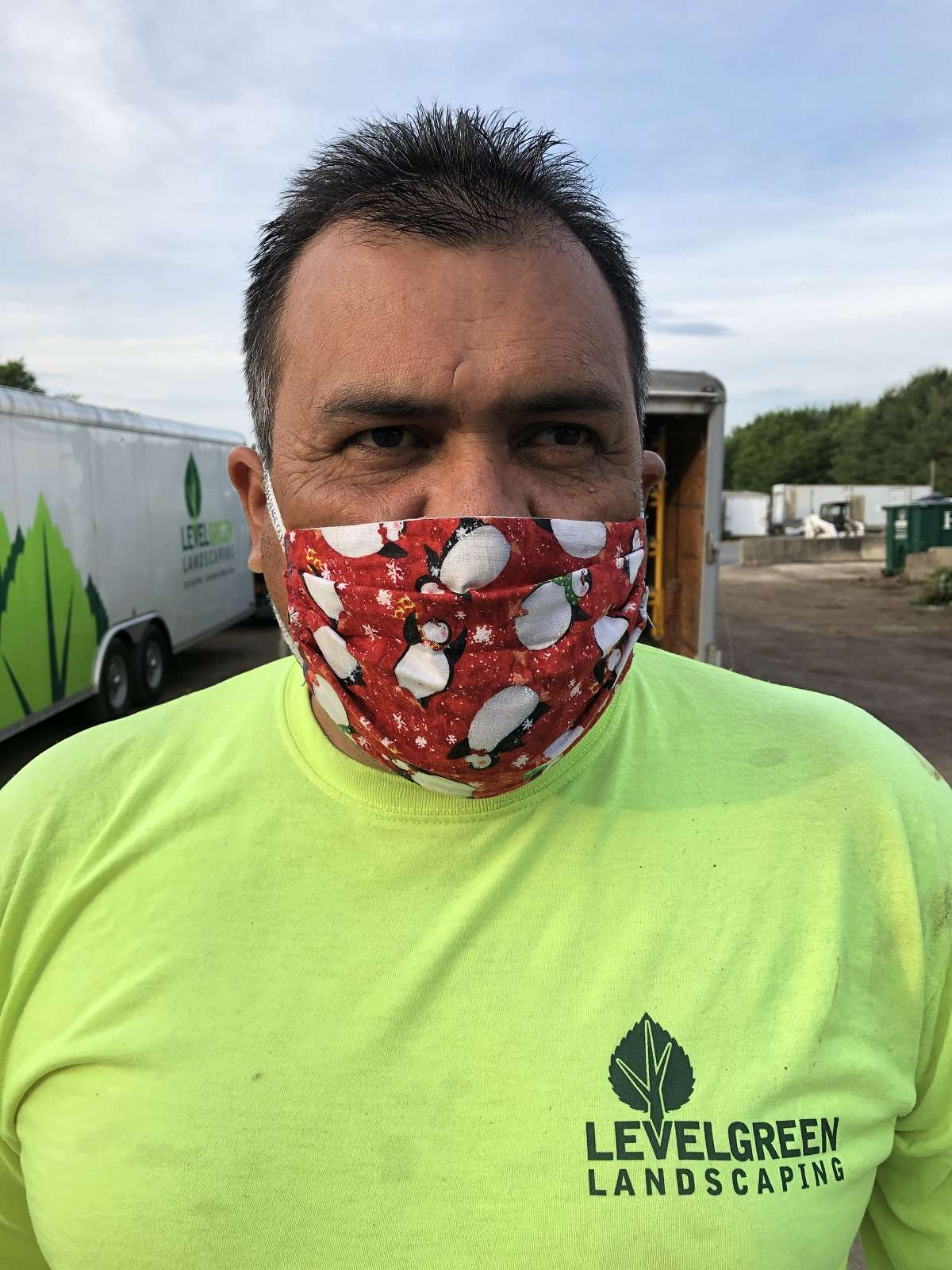 level Green employee wearing mask made by Joey's mom
