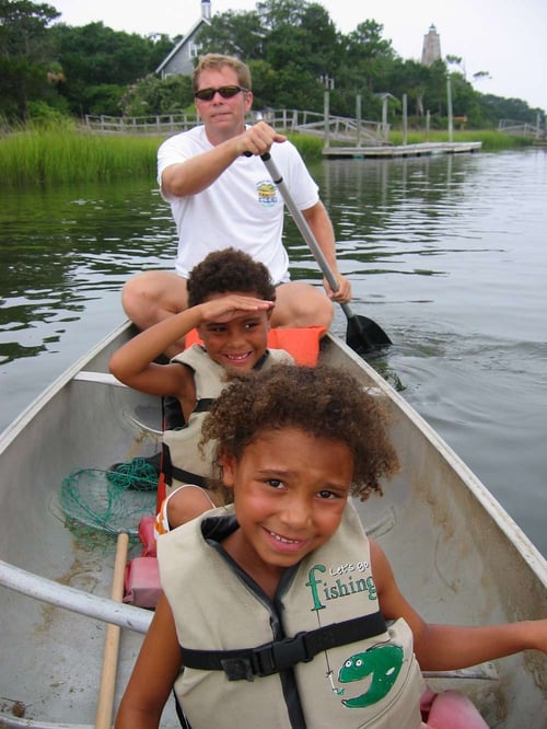 Larry Leon and his children in boat