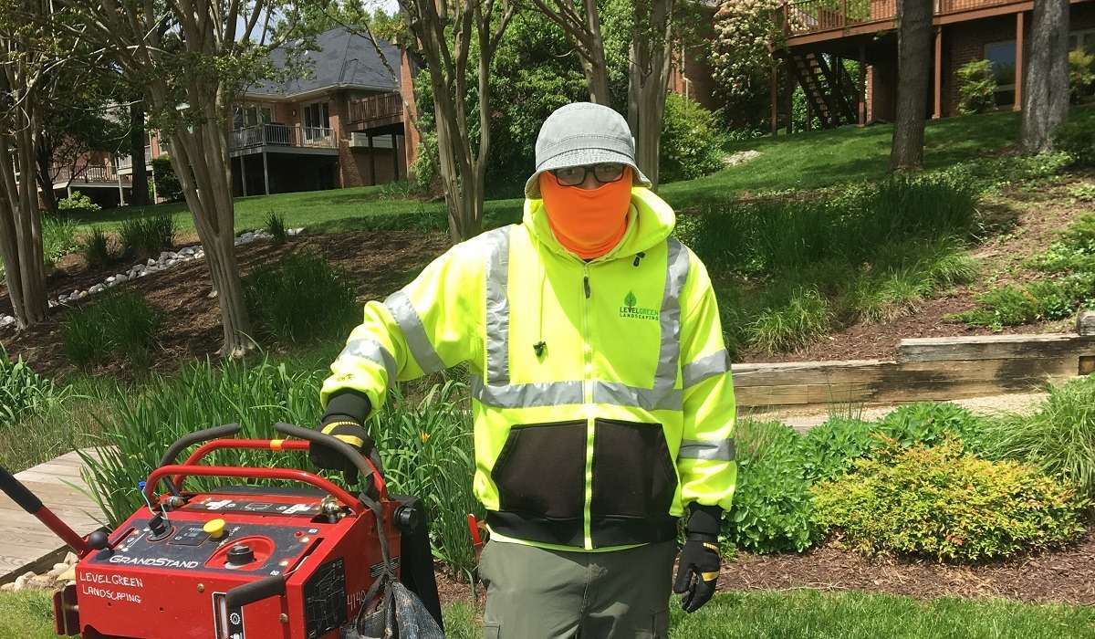 Level Green Landscaping team member with PPE