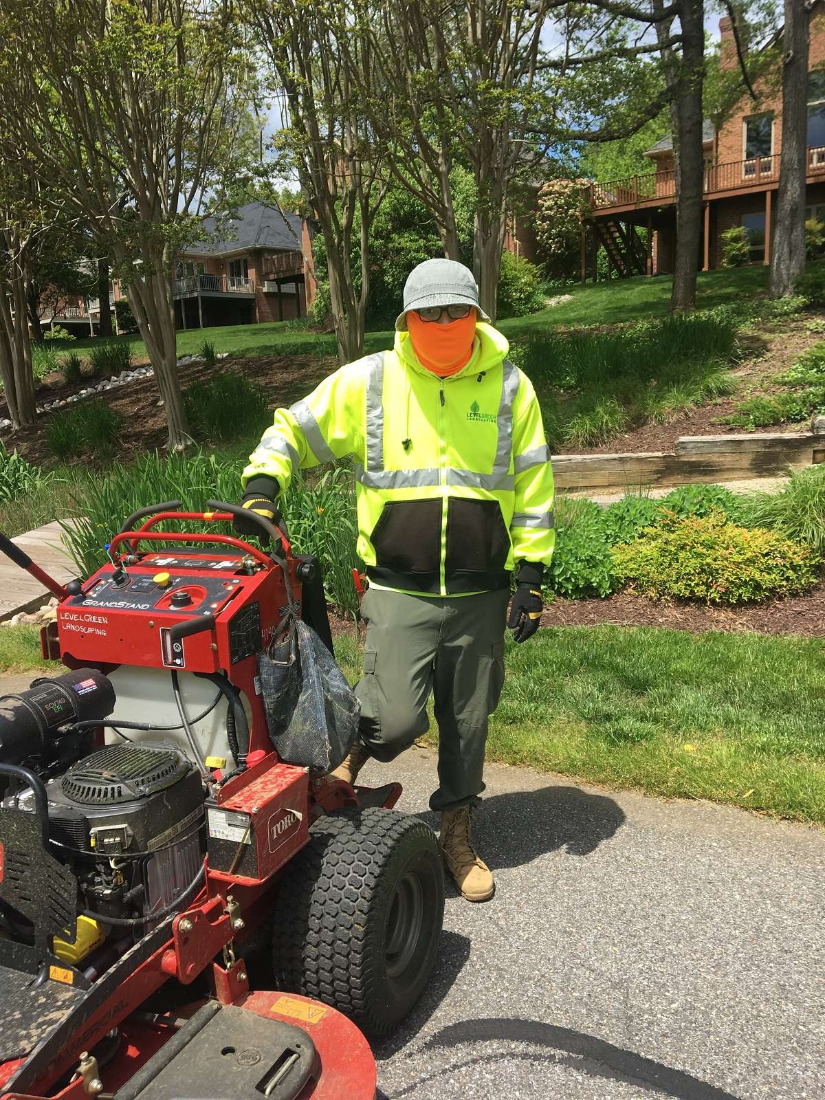 Level Green Landscaping crew member with face mask PPE