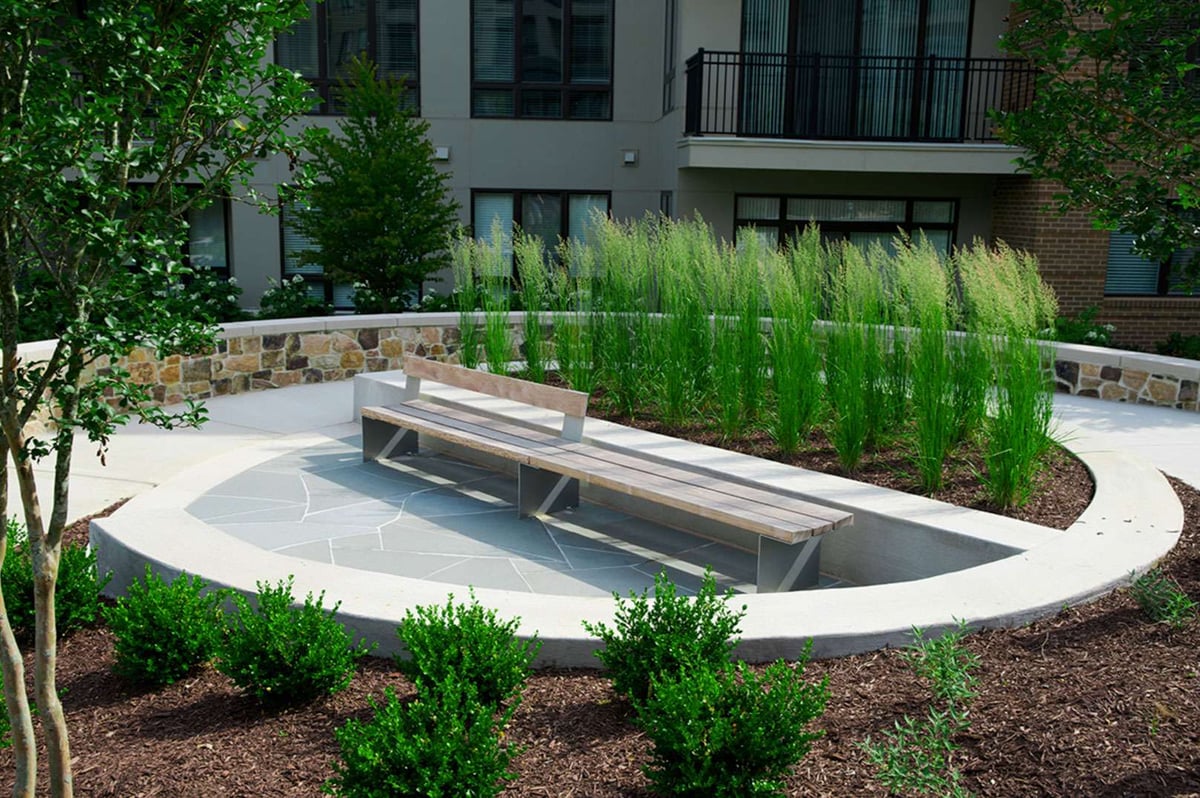 retaining wall ornamental grass seating area on patio  with boxwood shrub