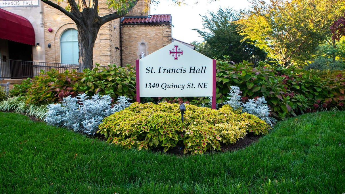 sign at church with flowers planted around it