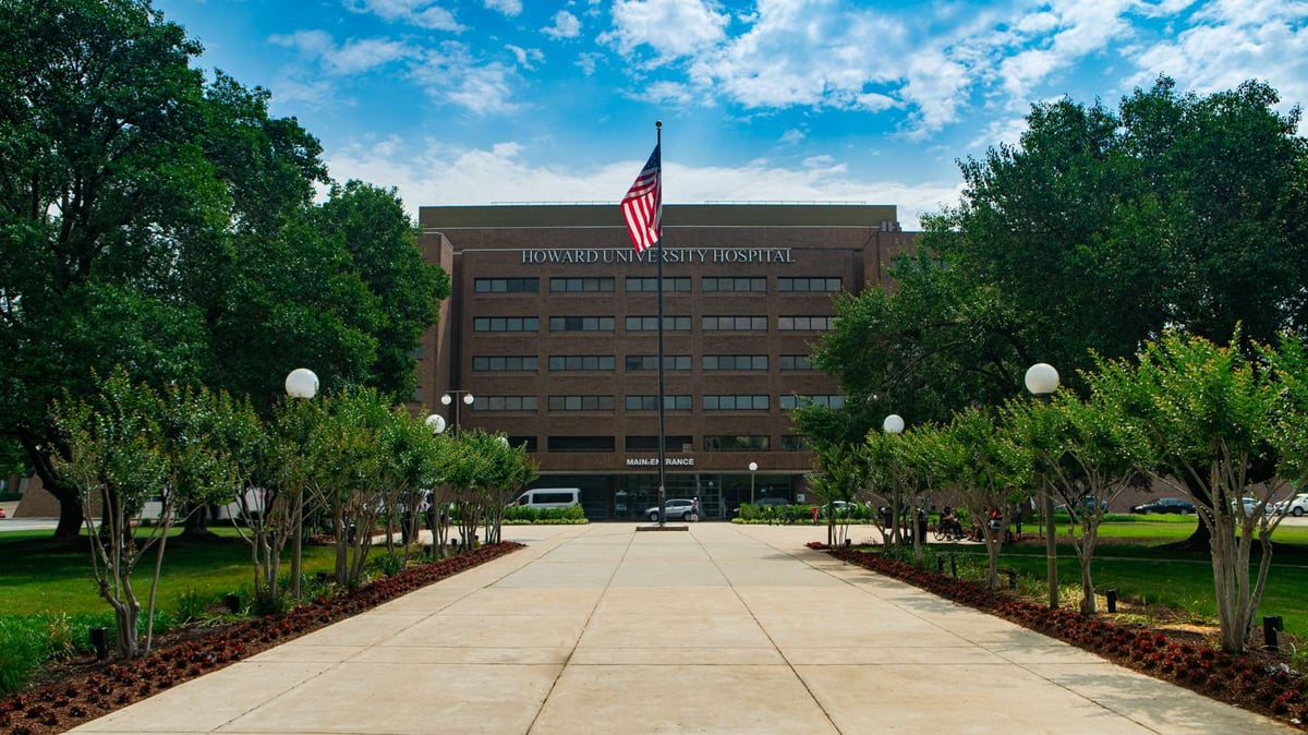 howard university hospital entrance with annual plantings and trees