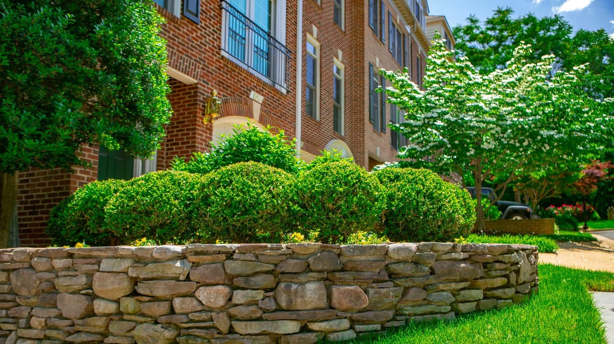 stone retaining wall with plantings at HOA