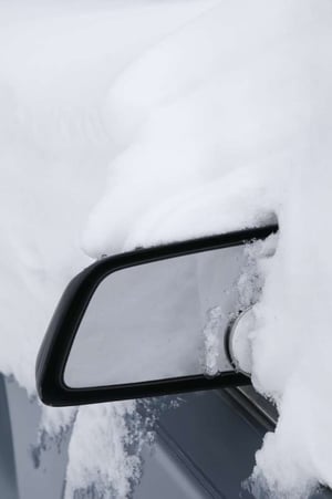 Winter at a glance heavy snow around car mirror