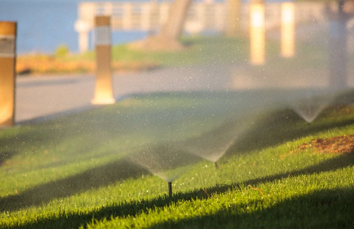 sprinkler heads water grass at commercial property