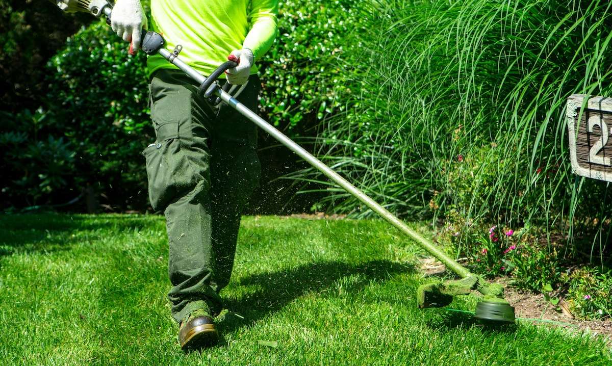 HOA landscape maintenance company trimming grass