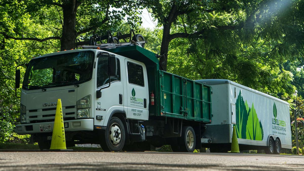 level green truck and trailer with safety cone